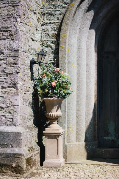 A classic urn filled with pretty, mixed foliage and splashes of colour