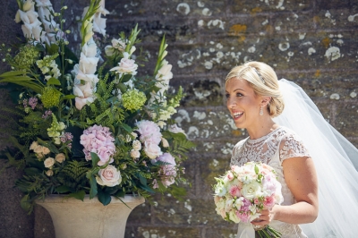 A mass of flowers and foliage in an urn outside the church to compliment the bride's bouquet