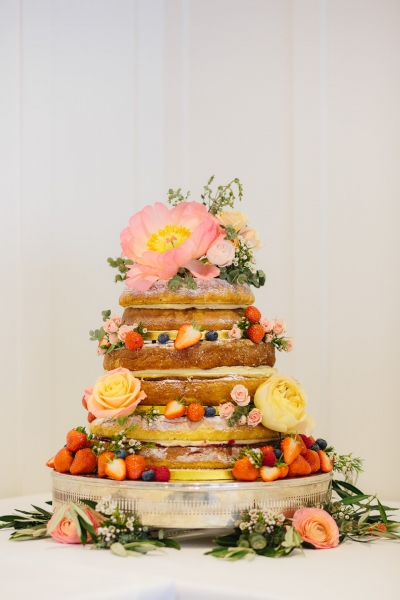 Peonies, roses and delicious fruit adorning a naked cake